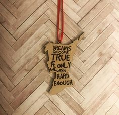 a wooden ornament that says dreams come true if only we wish hard enough