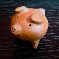 a small wooden pig sitting on top of a table