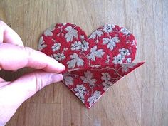 someone is making a heart out of fabric