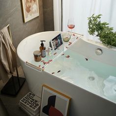 a bathroom with a bathtub and pictures on the wall