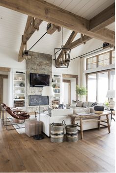 a living room filled with lots of furniture and a flat screen tv mounted to the wall