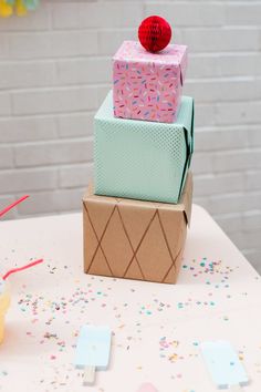 three boxes stacked on top of each other with confetti and sprinkles