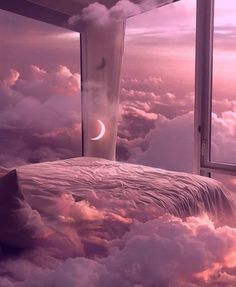 a bed sitting under a window on top of a cloud covered sky next to a moon