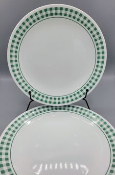 two green and white plates sitting on top of each other