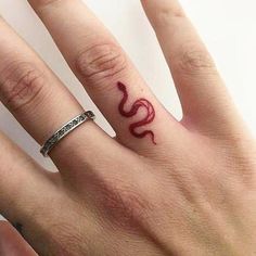 a woman's hand with a tattoo on it and the word love written in red ink