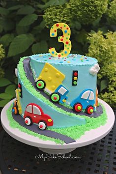 a birthday cake with cars and trucks on it