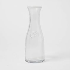 a clear glass vase sitting on top of a white table