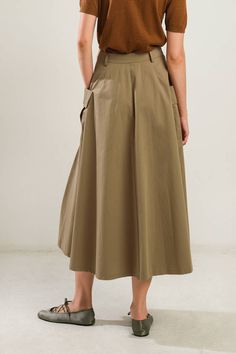 A solid woven full skirt featuring front closure and side pockets Details: Self : 100% Cotton Size & Fit - Model is 5`8" And Wearing Size Small- Measurements Taken From Size Small- Approx. Length: 33.5" Chic Long Cargo Skirt With Pockets, Chic Midi Cargo Skirt With Pockets, Chic Cargo Midi Skirt With Pockets, Fall Long Khaki Skirt, Fall Flared Skirt Bottoms With Pockets, Fall Flared Skirt With Pockets, Solid Cotton Skirt With Pockets, Casual A-line Skirt With Pockets, Spring A-line Bottoms With Pockets