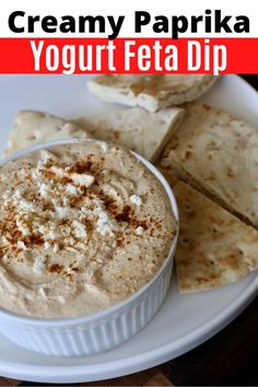 a bowl of creamy paprika yogurt feta dip with pita chips on the side