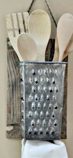 wooden spoons and spatulas in a metal grater with a quote about kitchen utensils