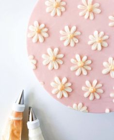 a pink cake with white flowers on it