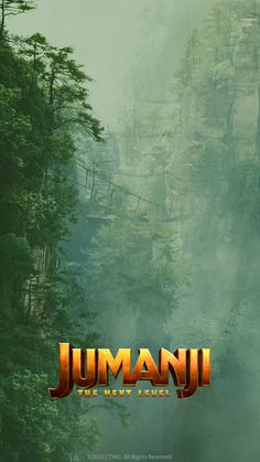 jumanji the next level movie poster with trees and mountains in the background on a foggy day