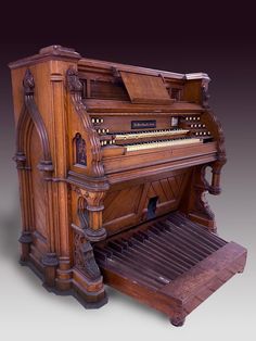 an old wooden organ sitting on top of a table