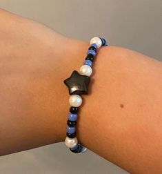 Black star with blue and black glass beads. Has pearl bead accents. Made with stretchy string. Blue Bracelet Beads, Black Beaded Bracelet, Blue Beaded Bracelets, Black Beaded Bracelets, Star Bracelet, Black Star, Blue Bracelet, Blue And Black, Blue Beads