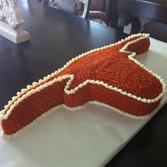 a cake shaped like a horse head sitting on top of a table