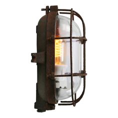 an old fashioned wall light with a caged design on the front and back side