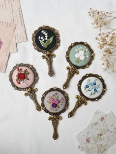 four different types of brooches sitting on top of a table