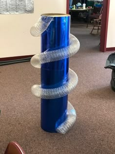 there is a very tall blue vase with plastic wrapped around it