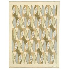 a rug with an abstract design on the front and back of it in green, blue,