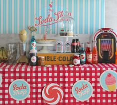 a red and white checkered table cloth with soda signs