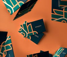 several folded business cards on an orange background