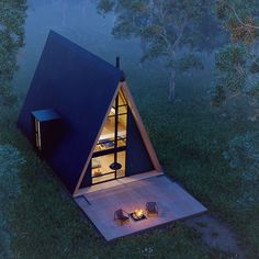 an aerial view of a small cabin in the woods at night, with lights on