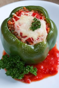 the stuffed peppers are covered with cheese and sauce on the plate, ready to be eaten