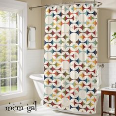 a colorful shower curtain in a bathroom next to a bathtub and window with the words modern gal written on it