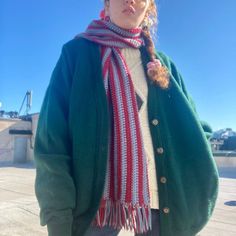 a woman wearing a green jacket and scarf