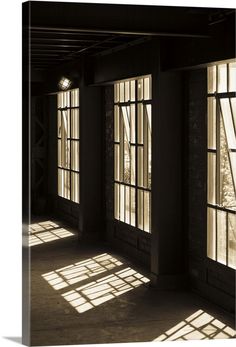 the sun shines through windows in an empty building