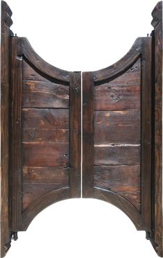 an old wooden gate that is open to reveal another door with the top section cut out