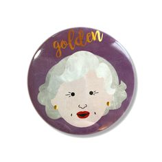 a purple button with an image of a woman's face and the word golden on it