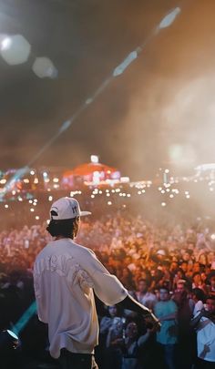 a man standing in front of a crowd at a concert