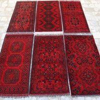 six red rugs laid out on top of each other in the shape of squares