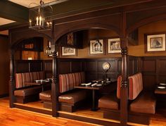 a restaurant with wooden booths and seating