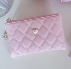 Beautiful pink vegan leather quilted pouch is the perfect accessory to hold all of your cards and information. Gold charm zipper details and pearl applique. Looks great paired with our Luxury pink quilted bag. Zipper Closure. Size: 6.5"W x 4"H Coquette Wishlist, Purse Inspiration, Pink Card Holder, Handbags Aesthetic, Pearl Applique, Quilted Pouch, Unique Tattoos For Women, Pink Wallet, Quilted Wallet