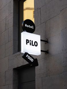 a hotel sign hanging off the side of a building