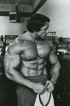 a black and white photo of a man with muscles