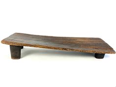 a wooden bench sitting on top of a white floor