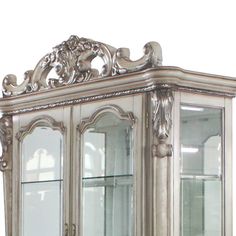 an ornate china cabinet with glass doors