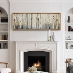 a living room filled with furniture and a fire place in front of a white fireplace