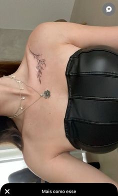 a woman with tattoos on her back laying down