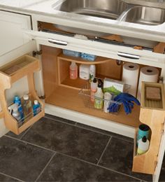 an open cabinet in the corner of a kitchen