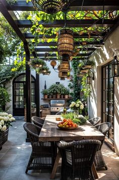 an outdoor dining area with wooden table and chairs