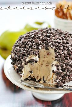 an ice cream cake with chocolate chips and peanut butter crunch topping on a white plate