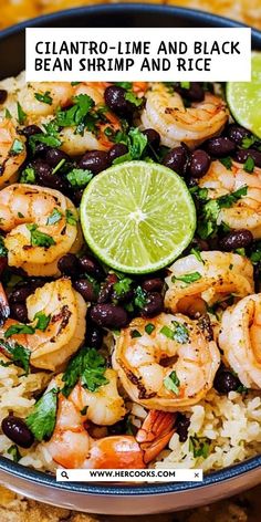 a bowl filled with shrimp, black beans and limes next to tortilla chips