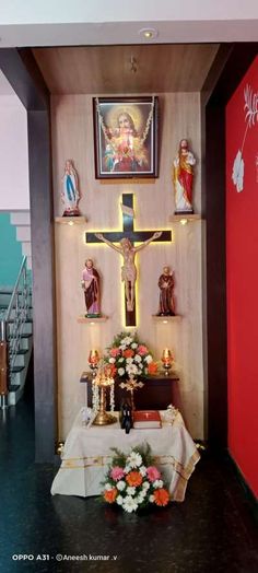 the altar is decorated with flowers, candles and crucifix in front of it