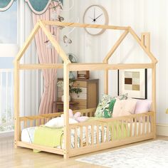 a child's bedroom with a wooden bed and pink curtains