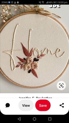 an embroidery pattern with the word love on it and some flowers in front of it