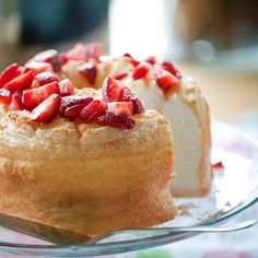 two pastries with strawberries on them sitting on a plate